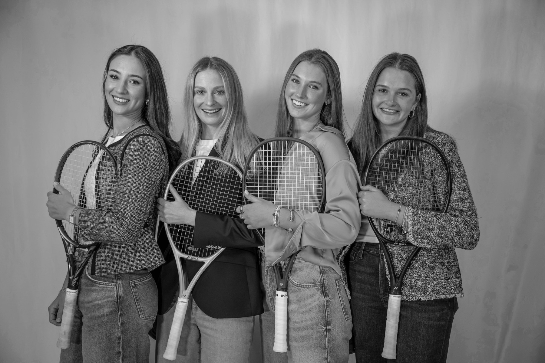 The four founders holding tennis rackets